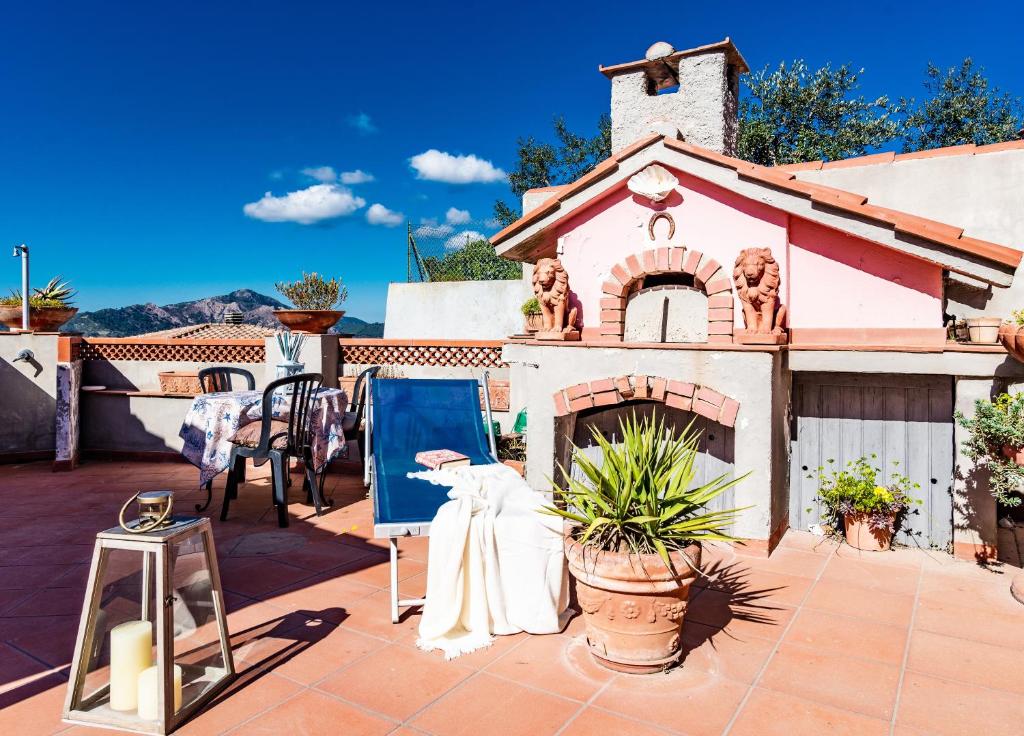 a patio with a painting and a house at Appartamento Anita in Capoliveri