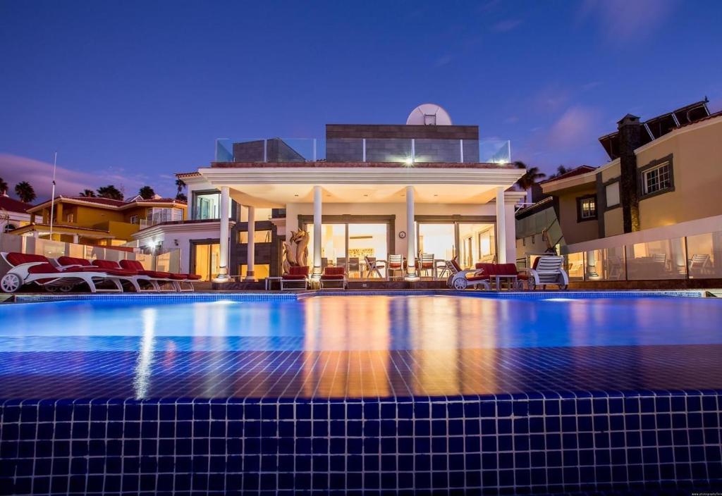 a large swimming pool in front of a house at Stunning Casa Bella Vista in Adeje