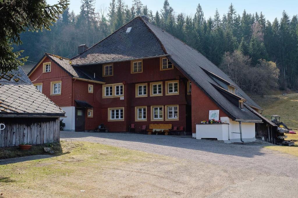 a large red house with a black roof at Alte Schmiede in Feldberg
