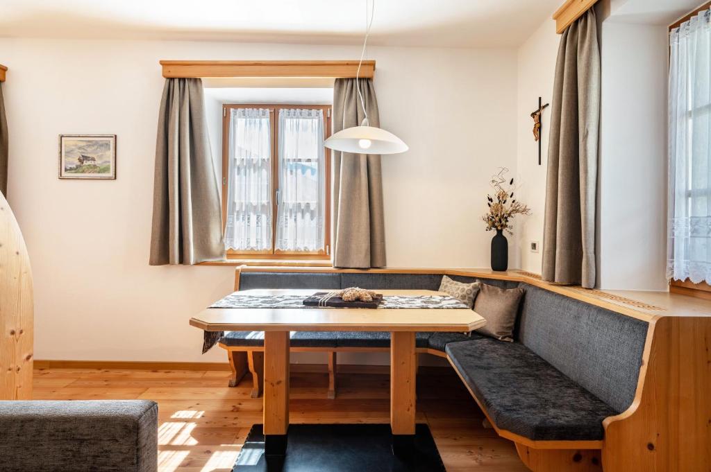 a living room with a table and a couch at Schreiberhof Panorama in Laion