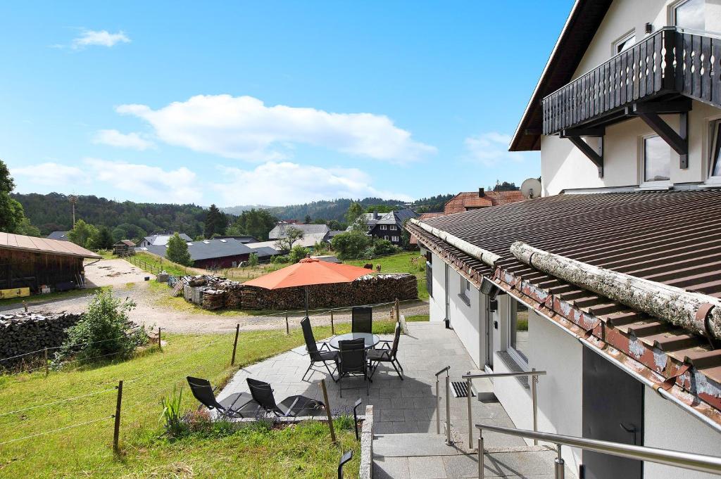 a balcony of a house with a table and chairs at Haus Fritz in Wittenschwand