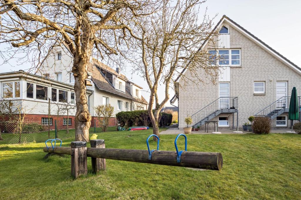 a playground in a yard in front of a house at Nordhaus Ferienwohnung 6 in Cuxhaven