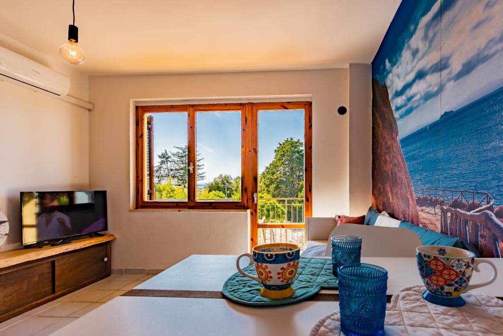 a living room with a table and a tv at Mono Le Lecce 38b in Capoliveri