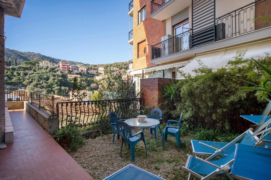 a patio with a table and chairs on a balcony at Alassio Mare E Non Solo 2 in Alassio