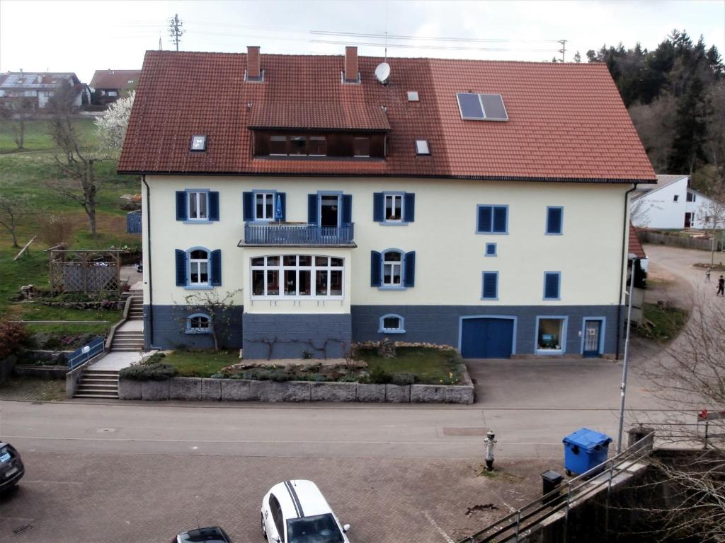 a large white house with a red roof at Ferienhaus Mülhaupt in Ühlingen-Birkendorf
