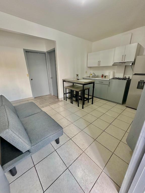 a living room with a couch and a table at Departamento privado in Tijuana