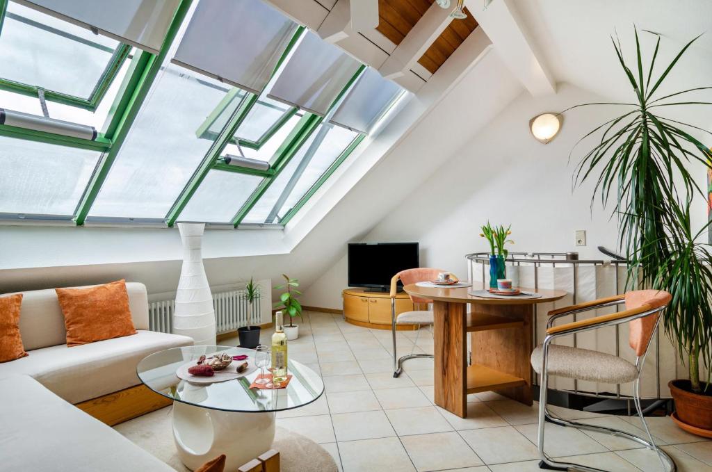 a living room with a couch and a table at Bodenseeblick in Meersburg
