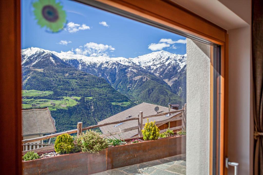 a window with a view of a mountain view at Flatschhof - Apartment Vermoi in Kastelbell-Tschars