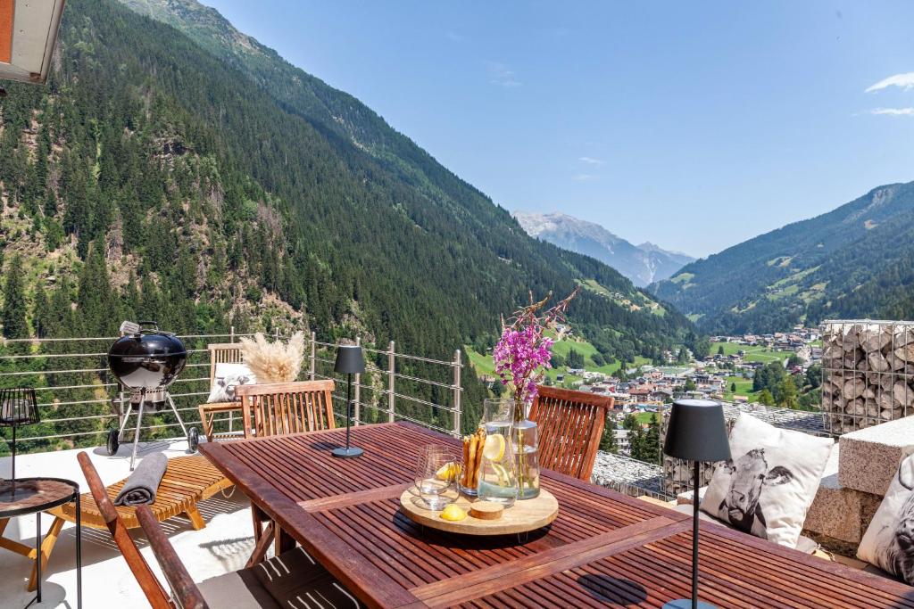 a table on a balcony with a view of a valley at Maierhof 341 in See