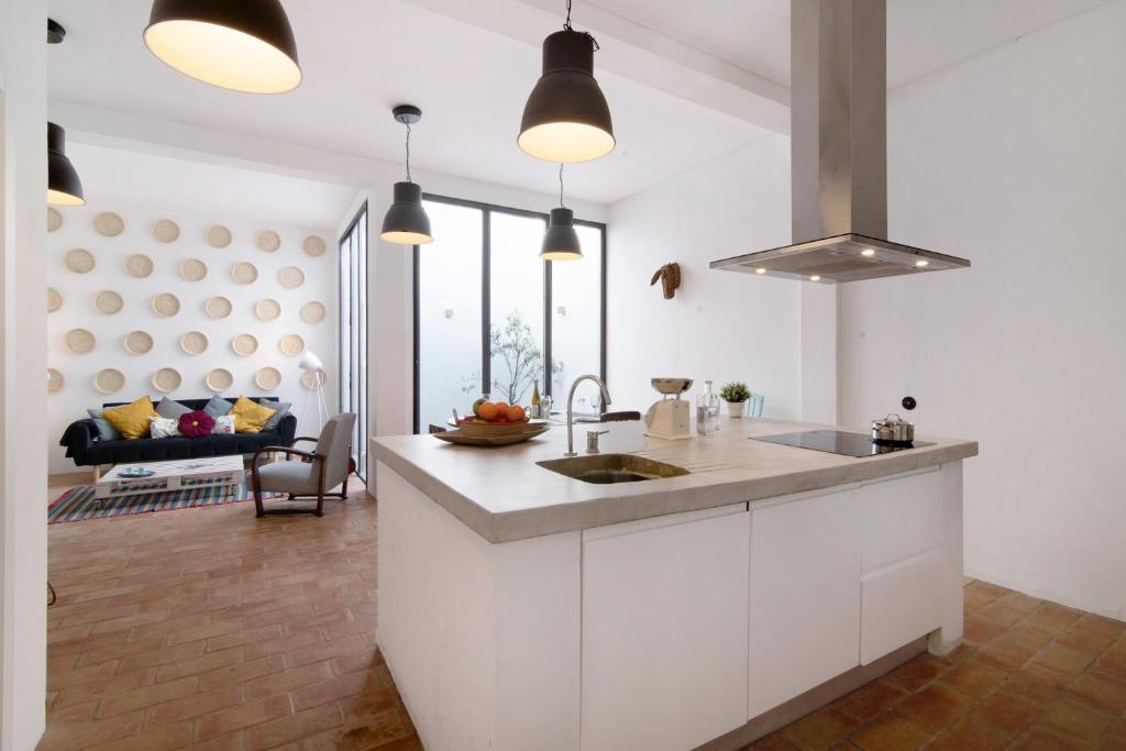 a kitchen with a sink and a counter top at Casa Loulé in Loulé