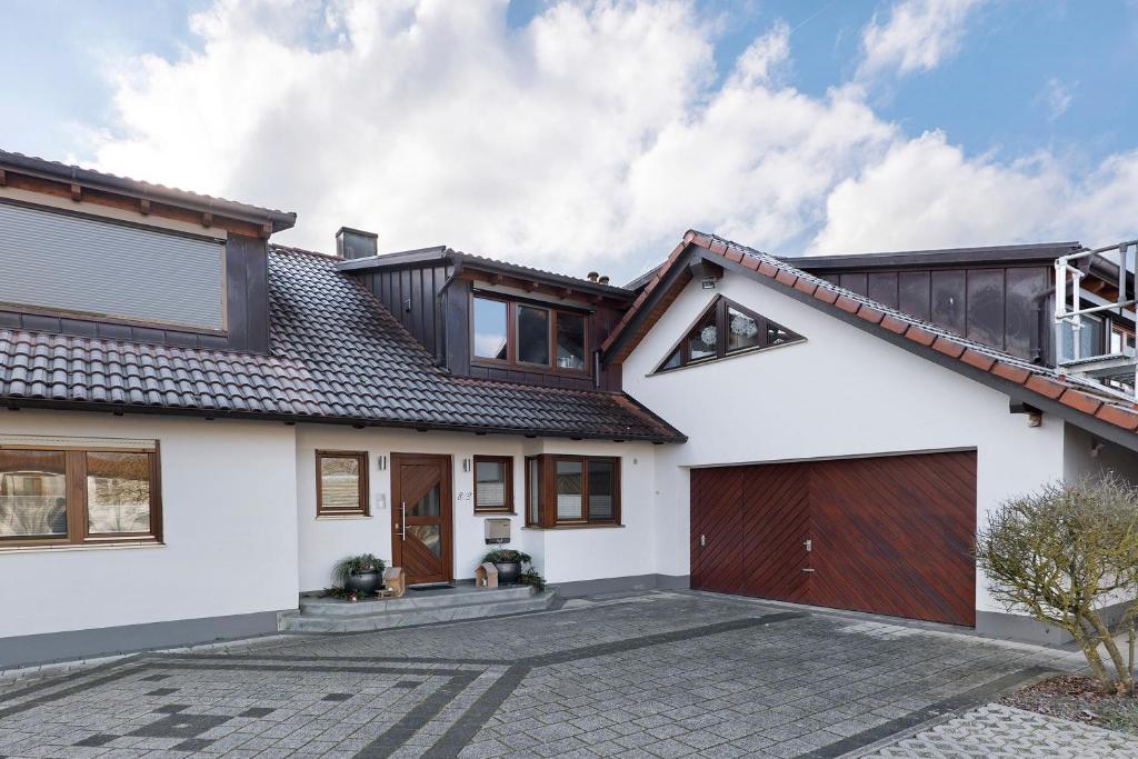a white house with a brown roof at Ferienhaus Landliebe in Ötisheim