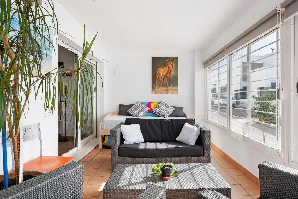a living room with a couch and a bed at Mirador del Palmar in Conil de la Frontera