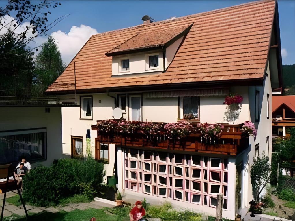 a house with a balcony with flowers on it at Haus Marianne Duffner in Schonach