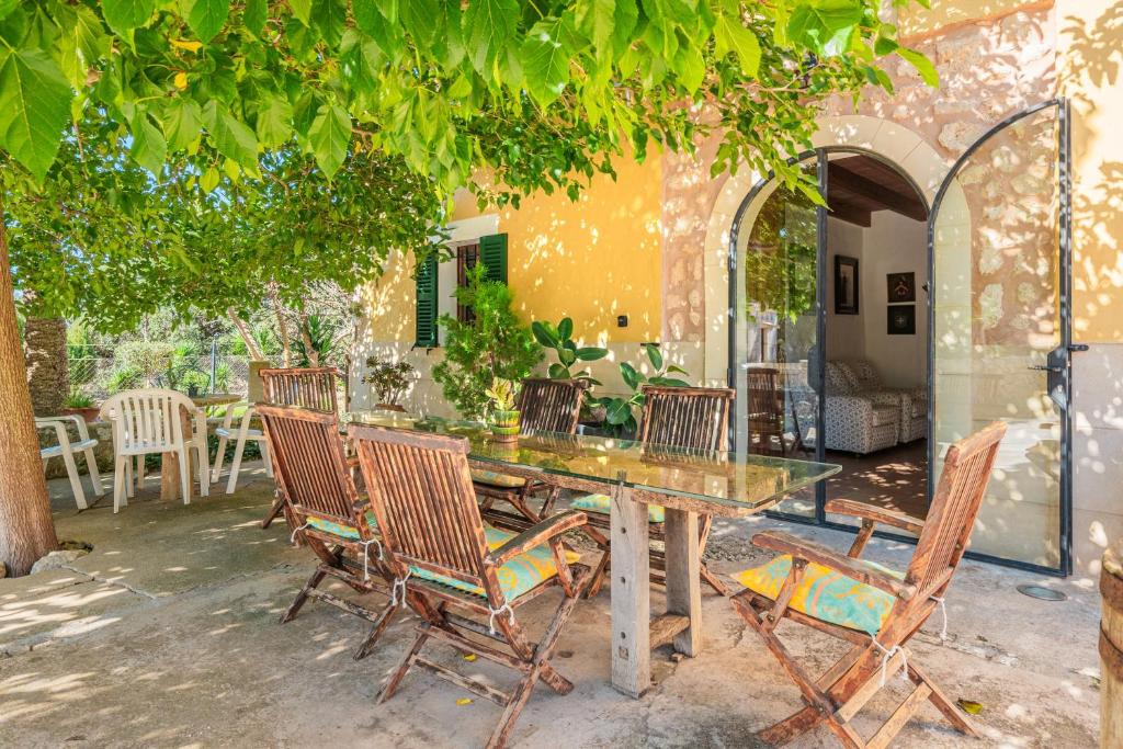 a table and chairs sitting under a tree at Ca S'hereu in Felanitx