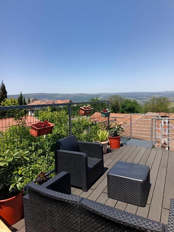a patio with chairs and tables on a balcony at D'ouro Prestige Relax in Sanfins do Douro