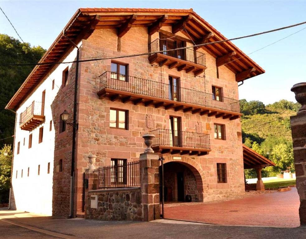 a large brick building with a balcony on it at Barbenea in Oronoz-Mugaire