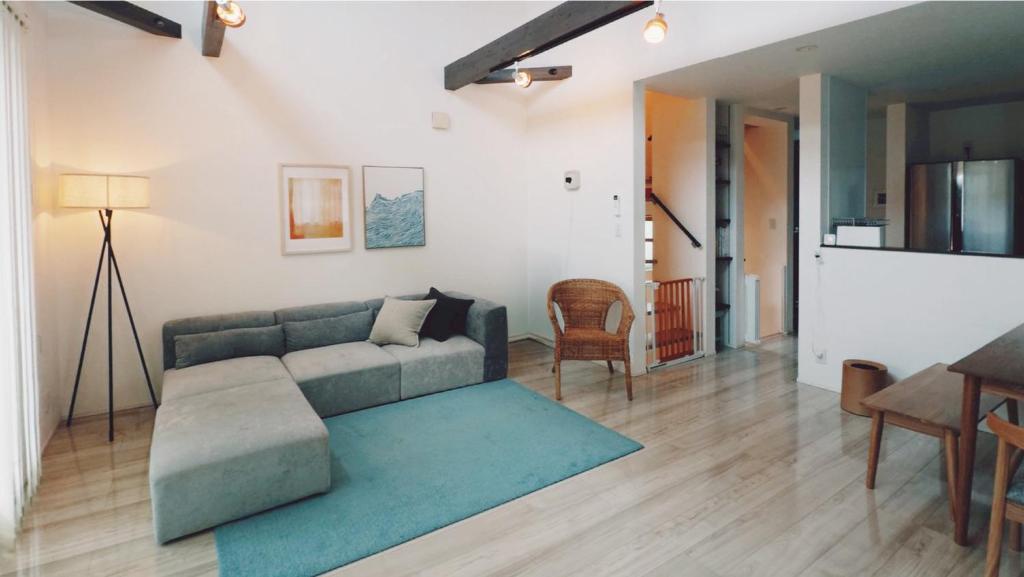 a living room with a couch and a table at Chigasaki Southern Beach House 茅ヶ崎サザンビーチハウス in Chigasaki