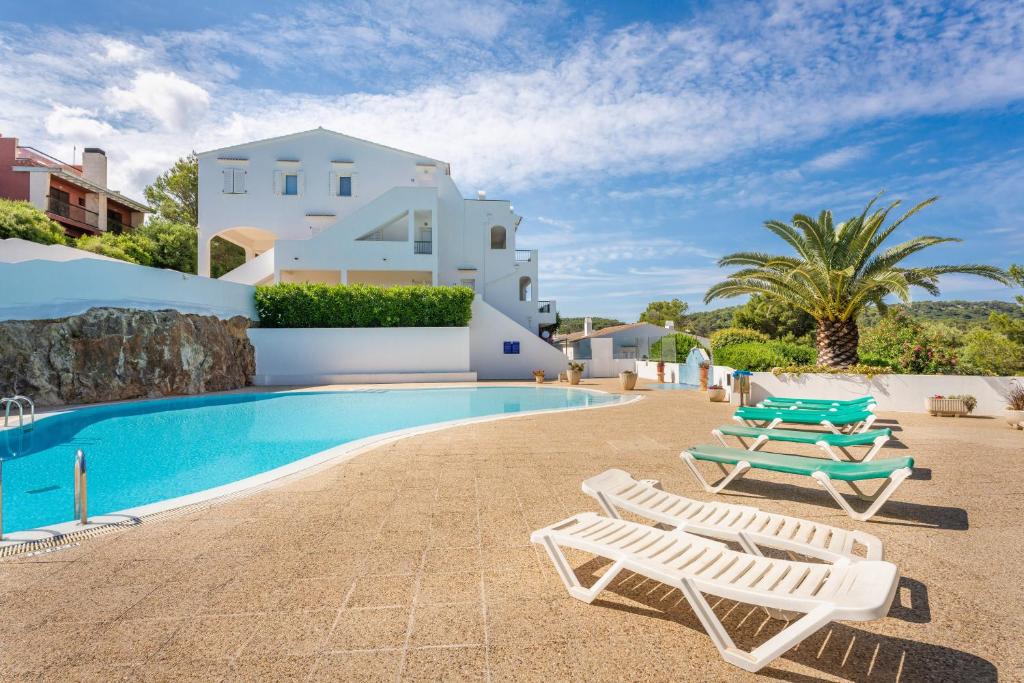 a villa with a swimming pool and two lounge chairs at Green Park B18 in Son Parc