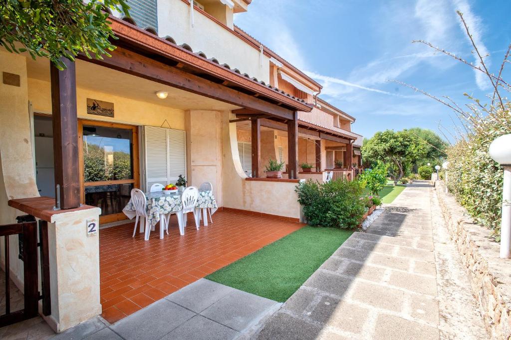a patio with a table and chairs on a house at Appartamento Cerri in Badesi