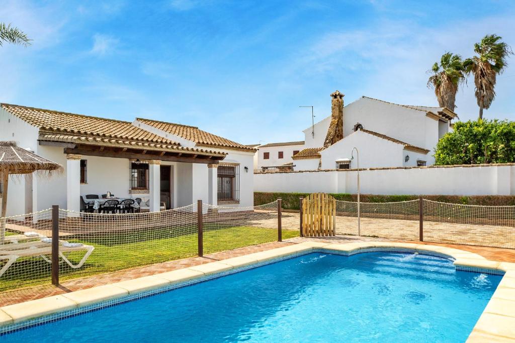a swimming pool in front of a house at Casa Ale in Cádiz