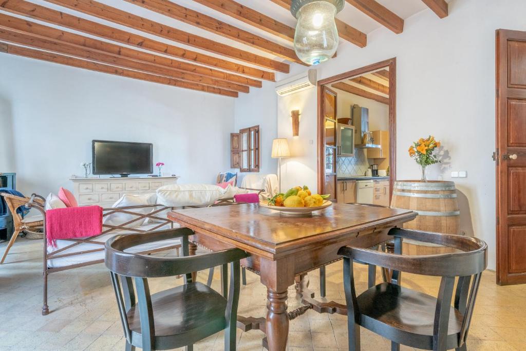 a dining room with a table with a bowl of fruit on it at Villa Can Got in Sóller