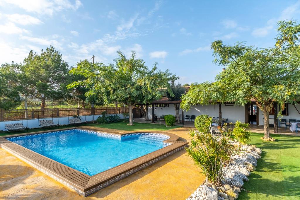 a swimming pool in the yard of a house at Finca Los Caleros - Algorfa in Algorfa