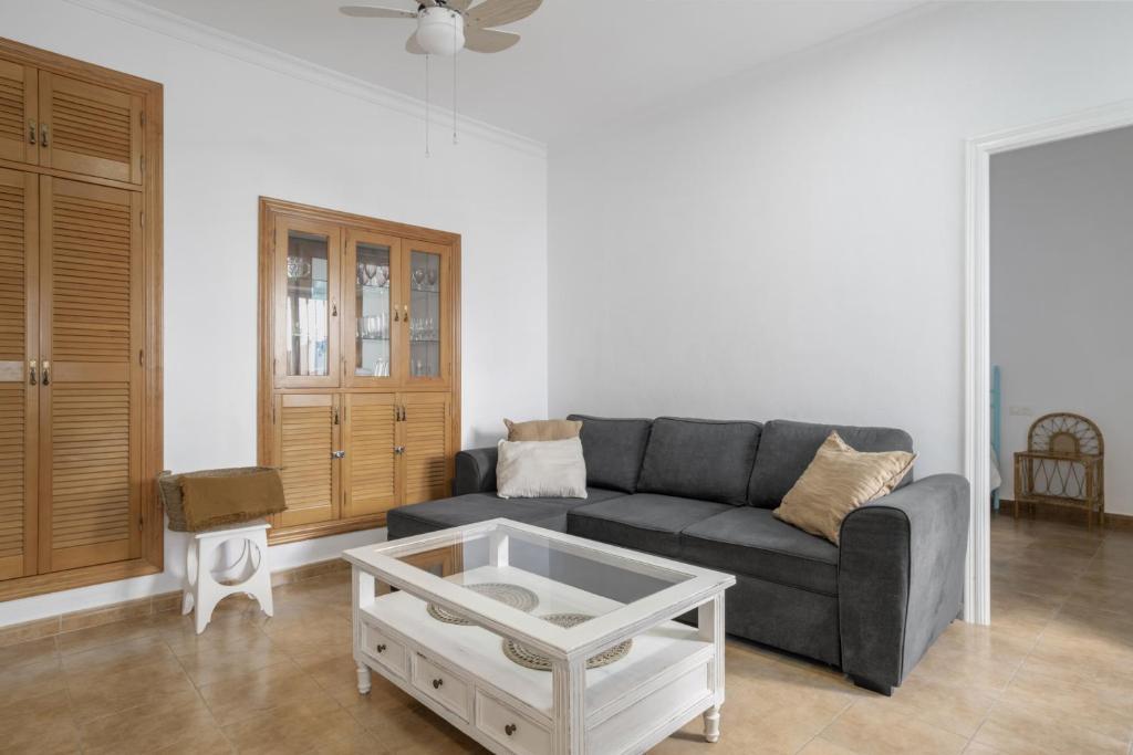 a living room with a couch and a coffee table at Casa Buganvilla in Barbate