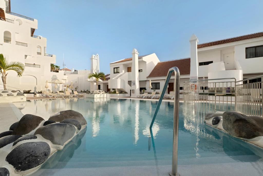 a swimming pool with seals in the water at Penthause Luxe 501 sea View pool in Playa Fañabe