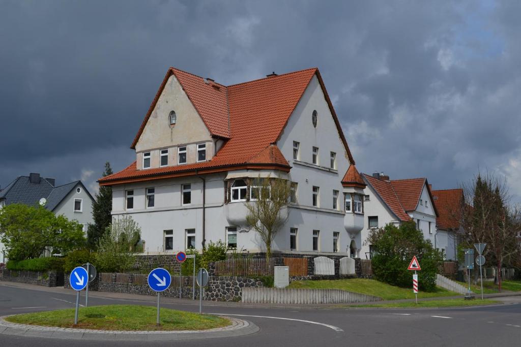 a large white house with a red roof at Apartment - Tor zur Rhön in Vachat