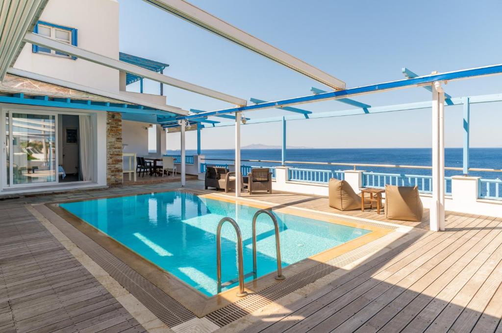 a swimming pool on the deck of a house at Blue Waves View Andros in Andros