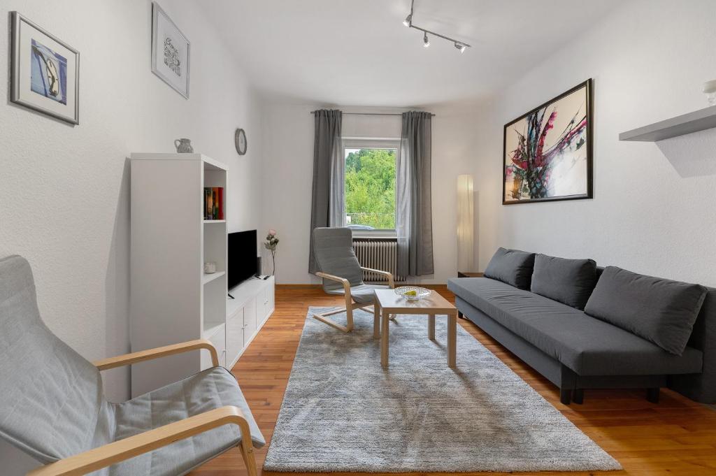 a living room with a couch and a table at Ferienwohnung Merzig in Merzig