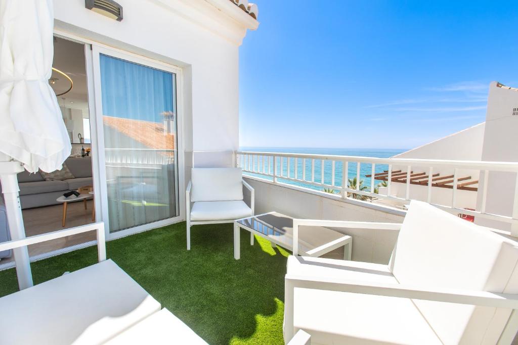 a room with a balcony with a view of the ocean at Luxury Sea view Apartment in Nerja
