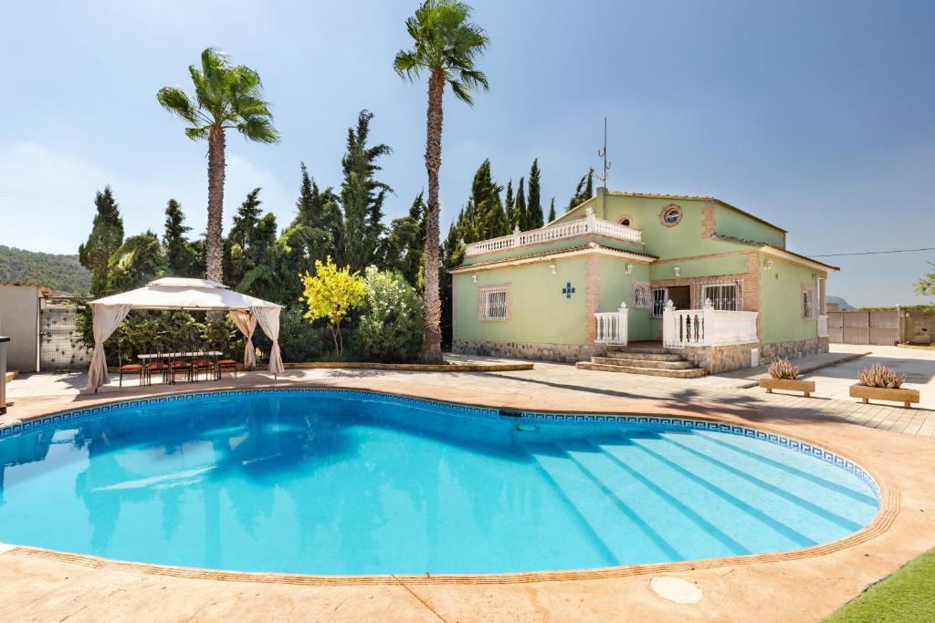 a large swimming pool in front of a house at Casa rural cavila in Pliego