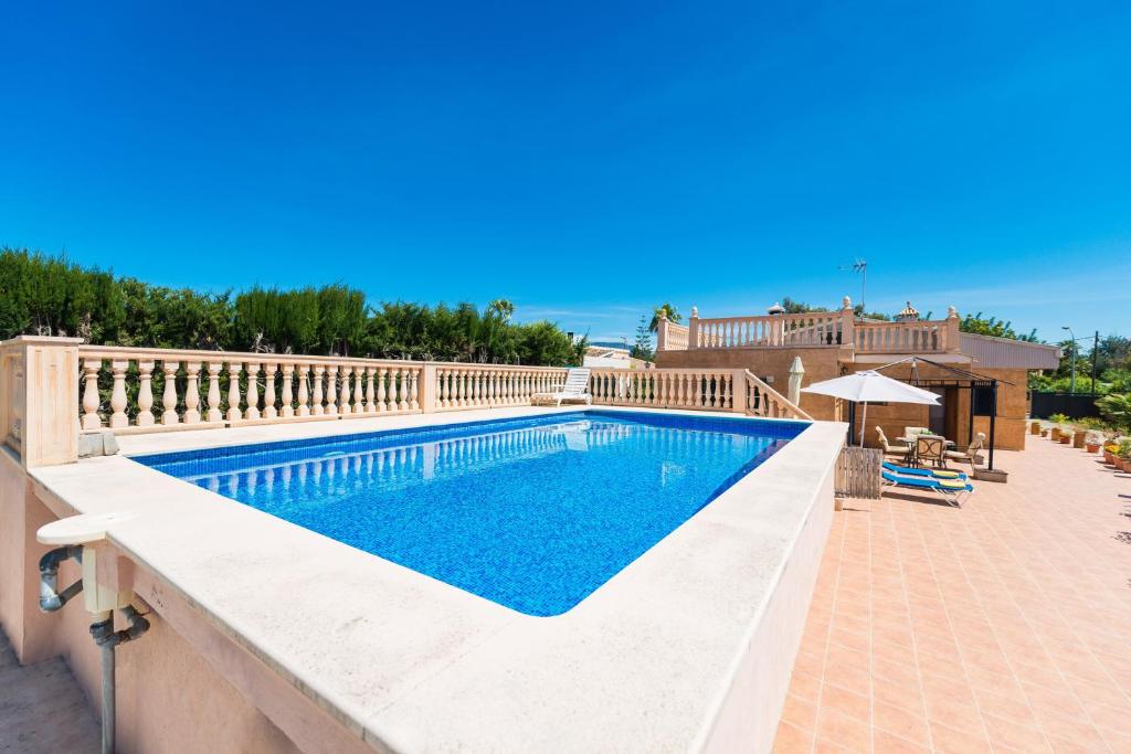 a swimming pool in a villa with a patio at Ses Llegitimes in Marratxí 