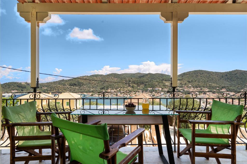 a table and chairs on a balcony with a view at Veroni's studio 1 in Vathi