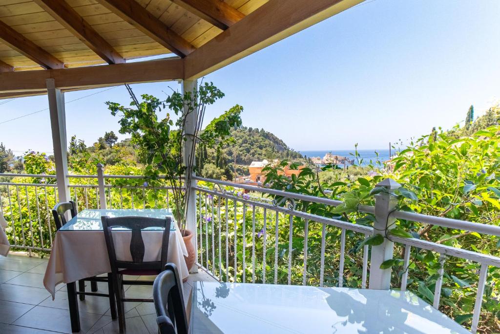 a balcony with a table and a view of the ocean at Arianna Studio Ground Floor 8 in Paleokastritsa