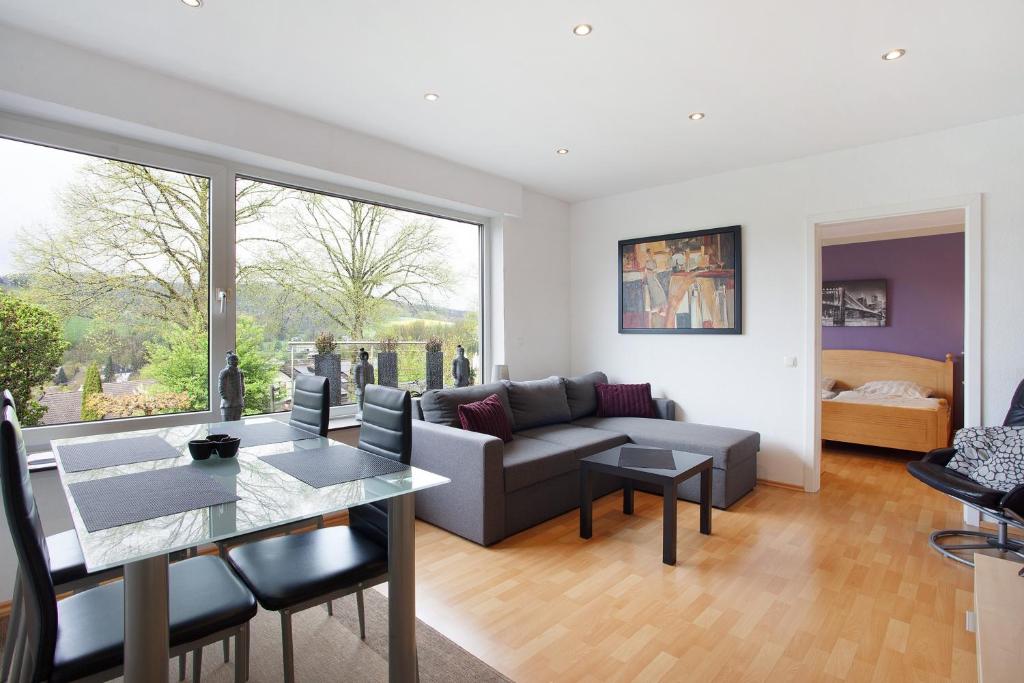 a living room with a couch and a table at Ferienwohnung Keil in Balve