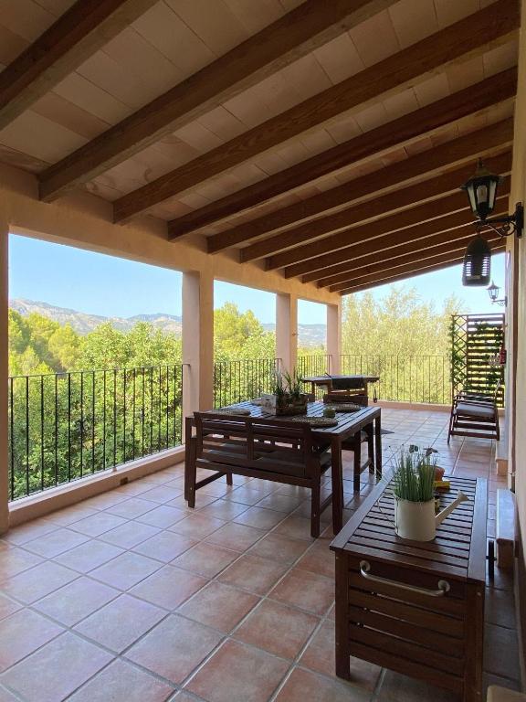 a patio with a table and benches and a balcony at The Paradise in Esporles
