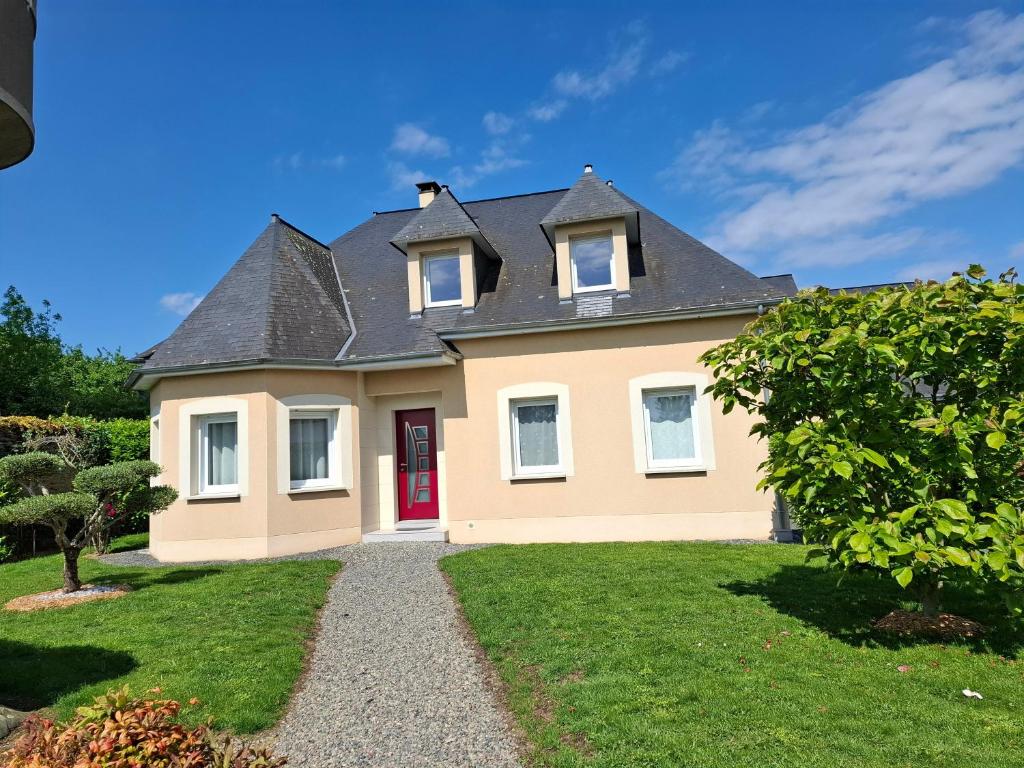 a large yellow house with a red door at Chambre D'hôte - La Capucine in Bazouges