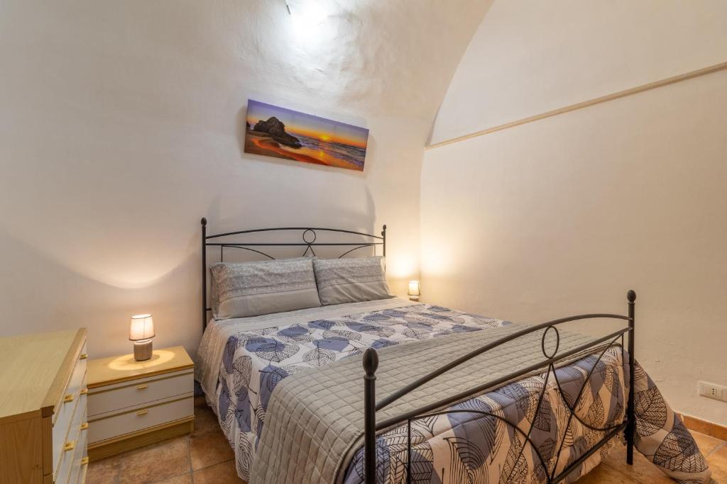 a bedroom with a bed and a dresser with a night stand at Casa Carmela 53 in Ragusa