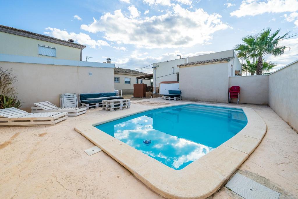 a swimming pool in the backyard of a house at Caseta de l'avi in Camarles