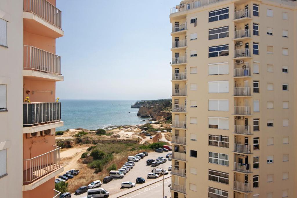 an aerial view of a parking lot between two buildings at Casa Ferrão in Armação de Pêra