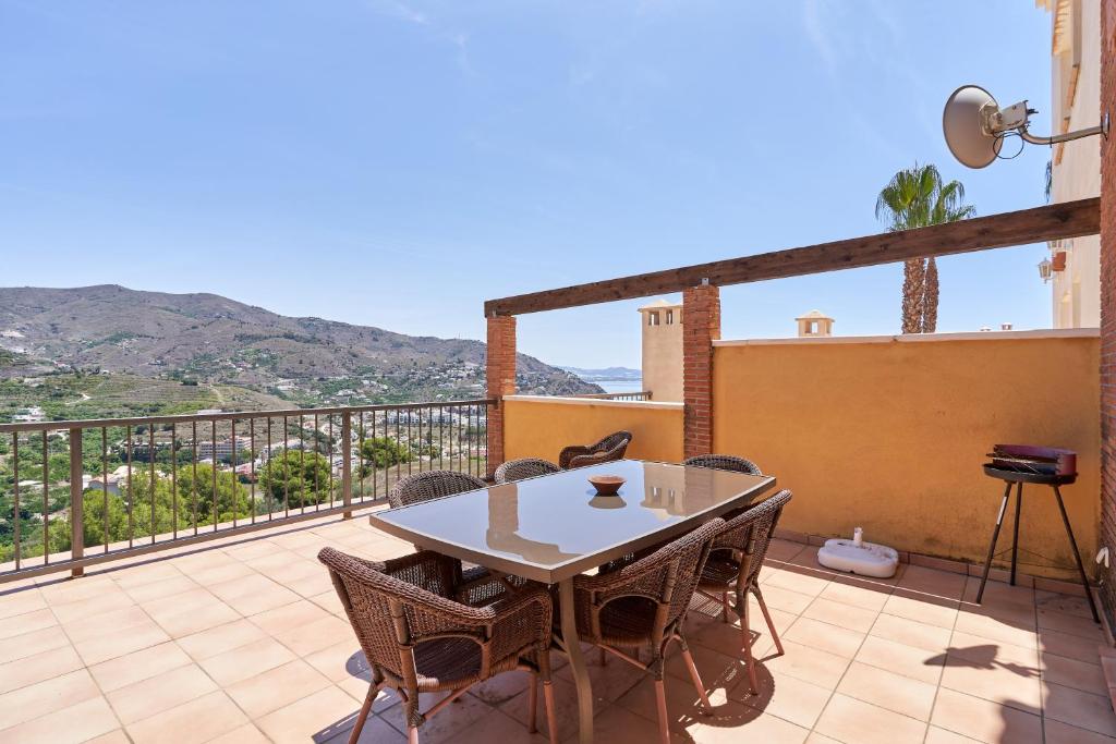 a patio with a table and chairs on a balcony at Casa Fuentes 2 B2 in Almuñécar