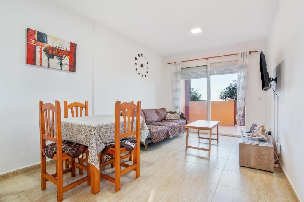 a living room with a table and chairs and a couch at Los Tinajones in La Oliva