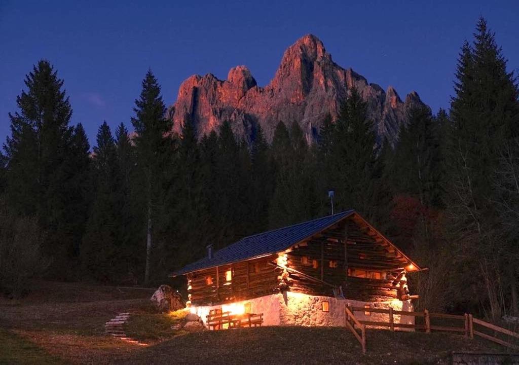 a log cabin at night with a mountain in the background at Maso 1445,Quiet, Breathtaking Views in Siror