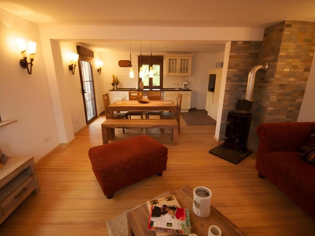 a living room with a couch a table and a fireplace at Ferienhaus Paula in Forbach