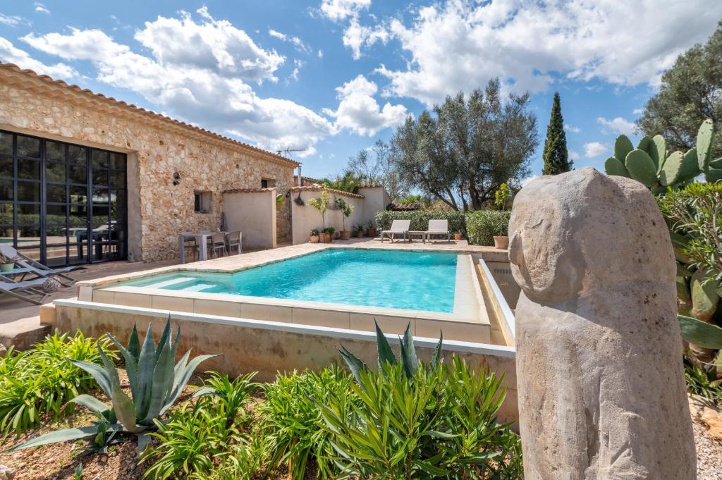 a villa with a swimming pool in a yard at Casa Cascada in Costitx