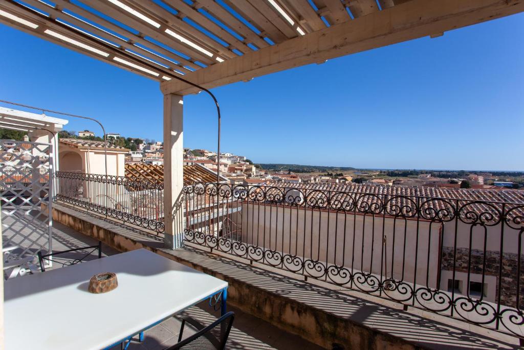 a balcony with a table and a view at Hora Mare in Orosei