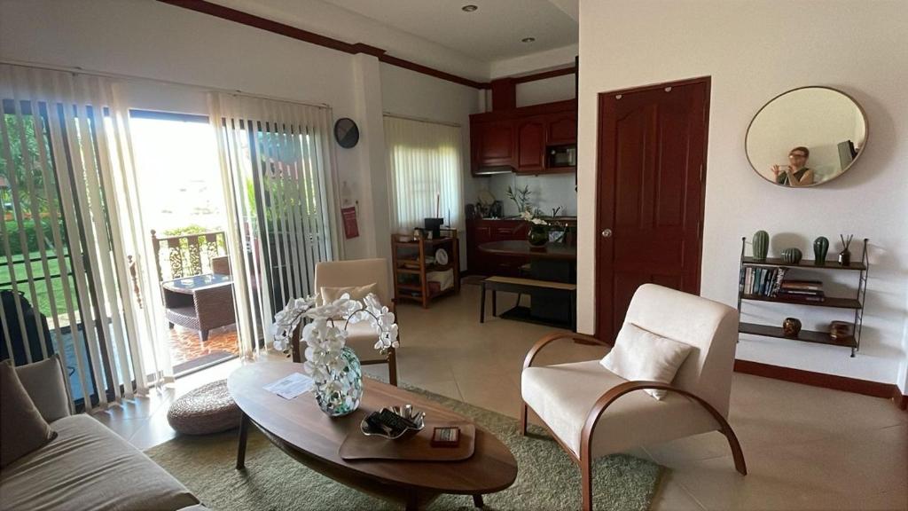 a living room with a table and chairs at Thailand Dream Village E09 in Klaeng