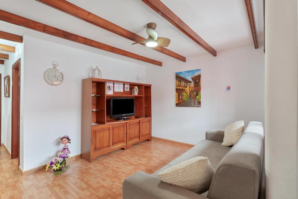 a living room with a couch and a tv at Villa Florymar in Ingenio